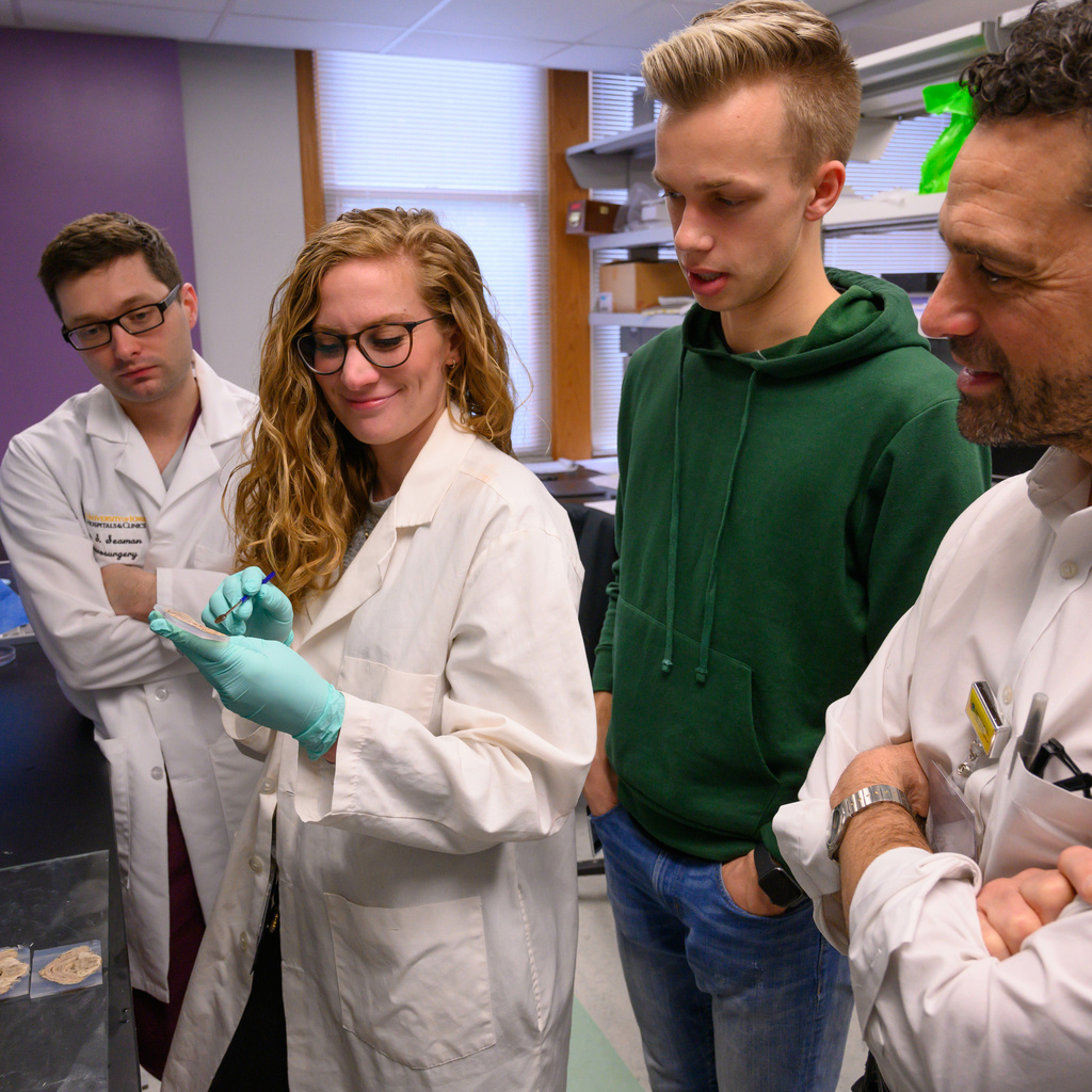Pictures of Neurosurgery residents working with faculty.