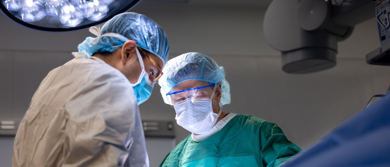 Jeremy Greenlee (green coat) performs a stage 2 subthalamic nucleus (STN) deep brain simulation (DBS) surgery with post doctoral clinical trainee Juan Vivanco Suarez on Monday, Dec. 16, 2024. 