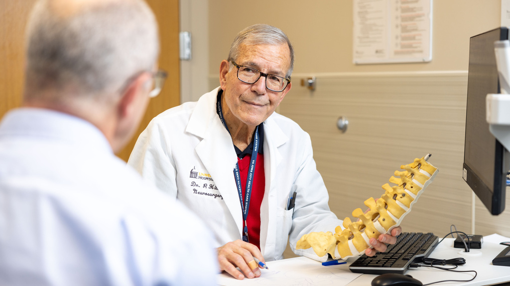 Patrick Hitchon in the neurosurgery clinic with simulated patients (employees) on Monday, Dec. 18, 2023.