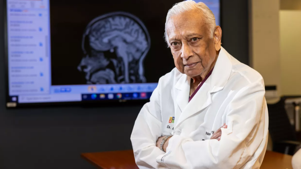 Dr. Arnold Menezes portrait within a conference room