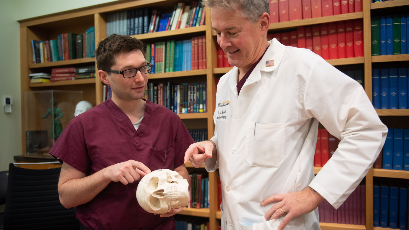 Pictures of Neurosurgery residents working with faculty.