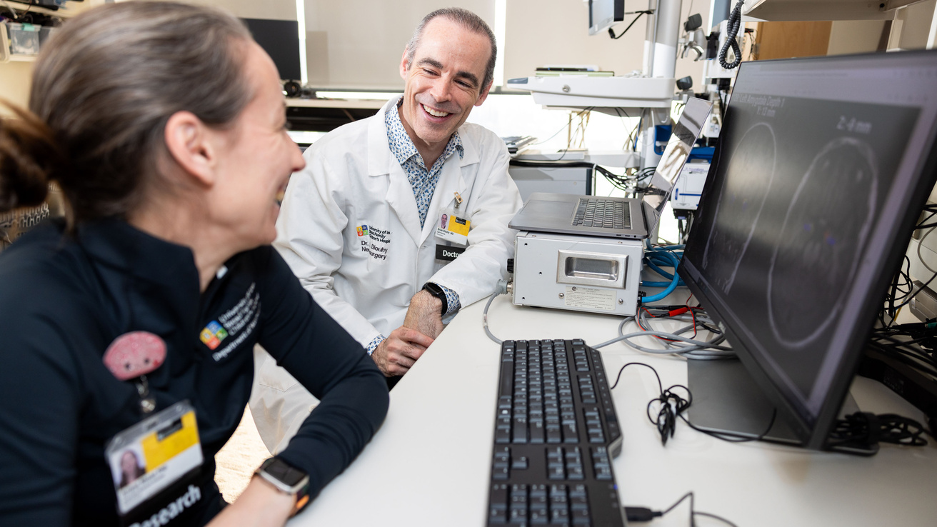 Brian Dlouhy and associate research scientist Ariane Rhone in their lab at University of Iowa Stead Family Children’s Hospital on Monday, Dec. 18, 2023. Dlouhy led a study that finds that the brain’s amygdala is linked to persistent loss of breathing after an epileptic seizure. Patients undergoing epilepsy surgery had electrodes implanted in their brains to help plan their surgeries; combining the intracranial recordings from these electrodes with functional MRI allowed researchers to map the effect of stim